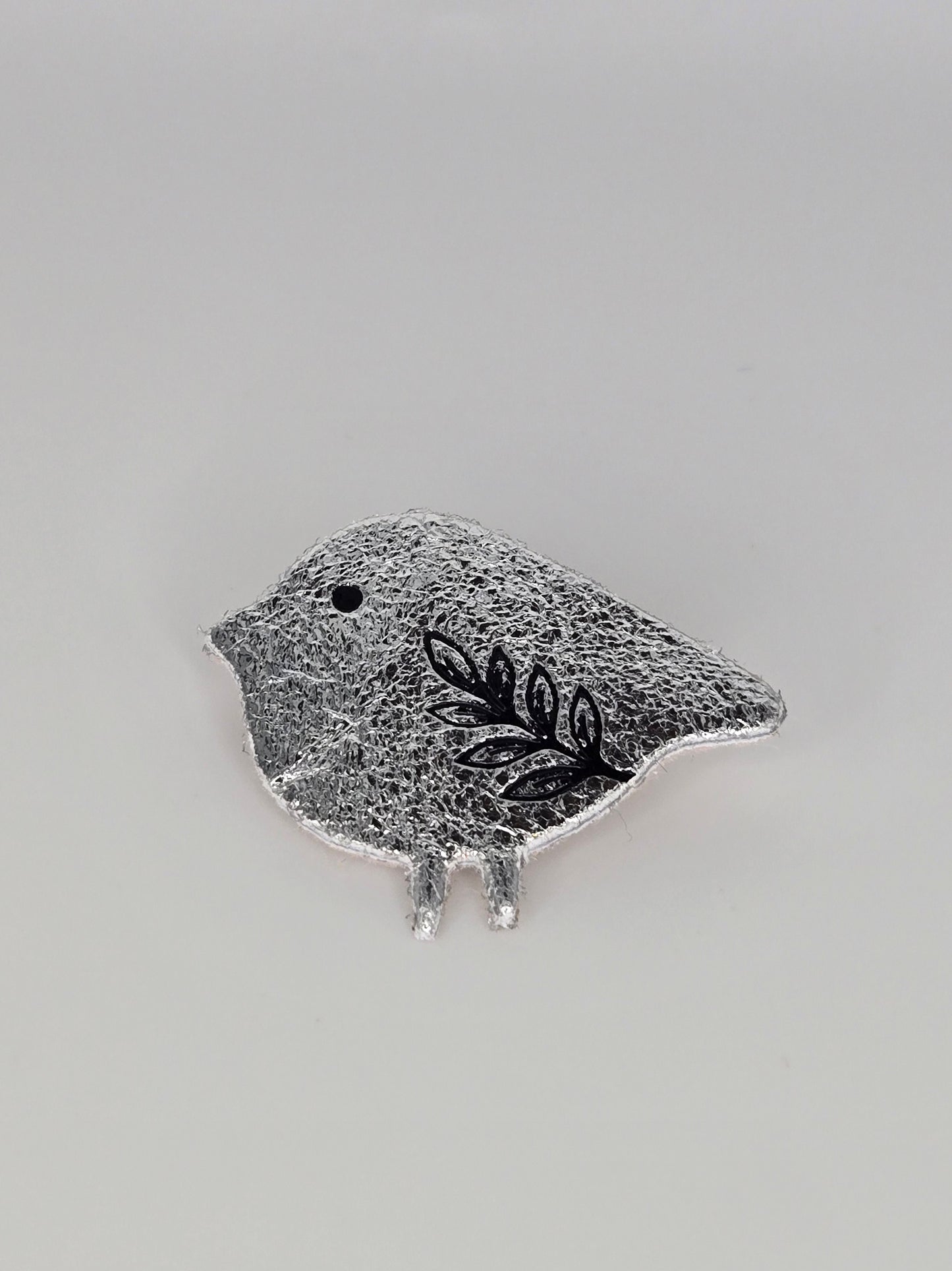 Silvered bird brooch