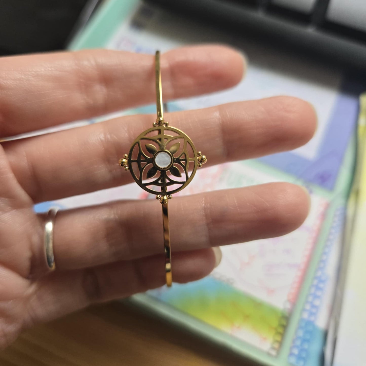 Gilded bangle with flower